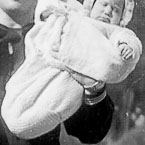 Dave holding babies Elaine and Judy. Melvin and Victor below